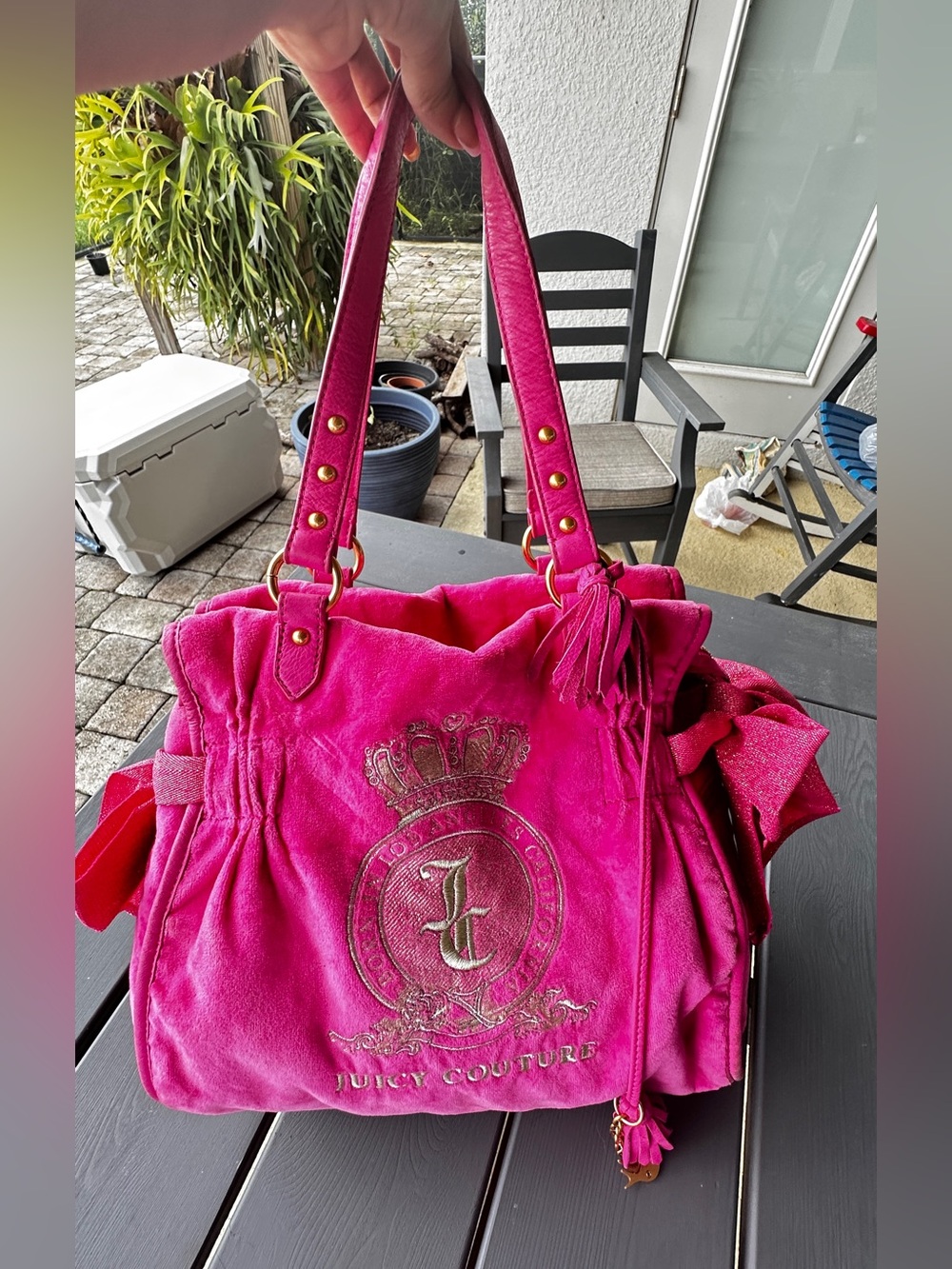 vintage hot pink velour Juicy Couture shoulder bag with gold crest embroidery.